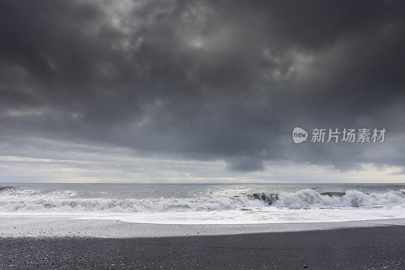 waves at the black sand beach near Hjörleifshöfði, a volcanic mountain in southern Iceland